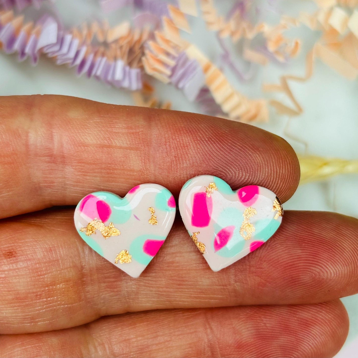 Pastel pink heart stud earrings with a spring blossom design, featuring pinks, mint green, and rose gold foil.