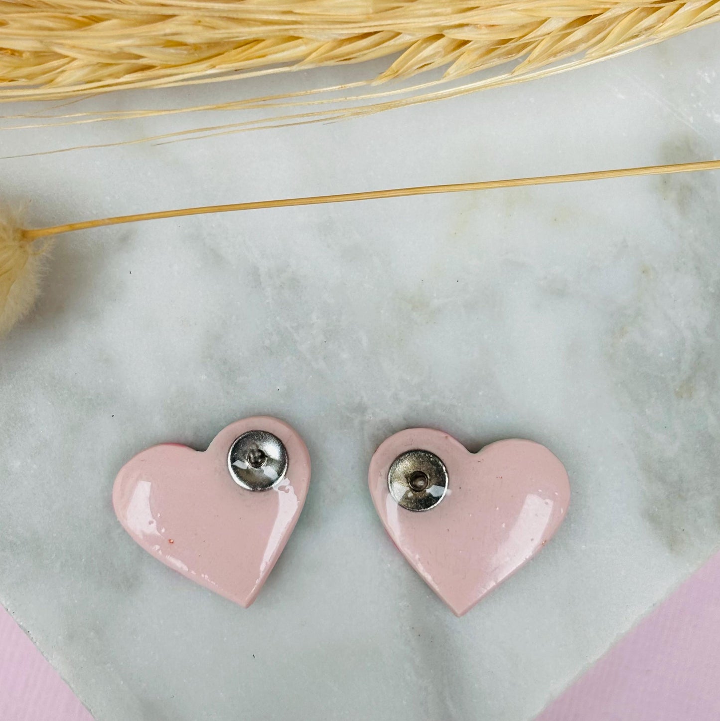 Pastel pink heart stud earrings with a spring blossom design, featuring pinks, mint green, and rose gold foil.