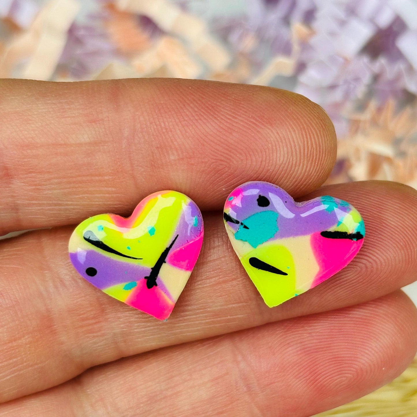 Colourful 80s disco-inspired heart-shaped stud earrings, handmade with polymer clay. Features vibrant colors and unique designs.