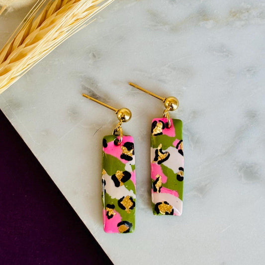 Elegant leopard print drop earrings with gold foil accents, handmade with polymer clay.