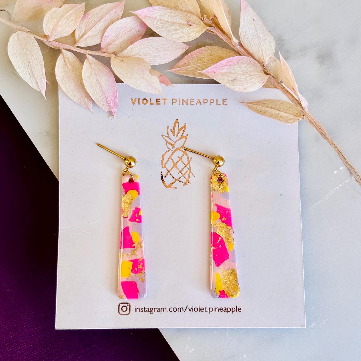 Delicate pastel drop stud earrings with soft pink, blue, and yellow hues and shimmering gold foil detailing, handcrafted from polymer clay.
