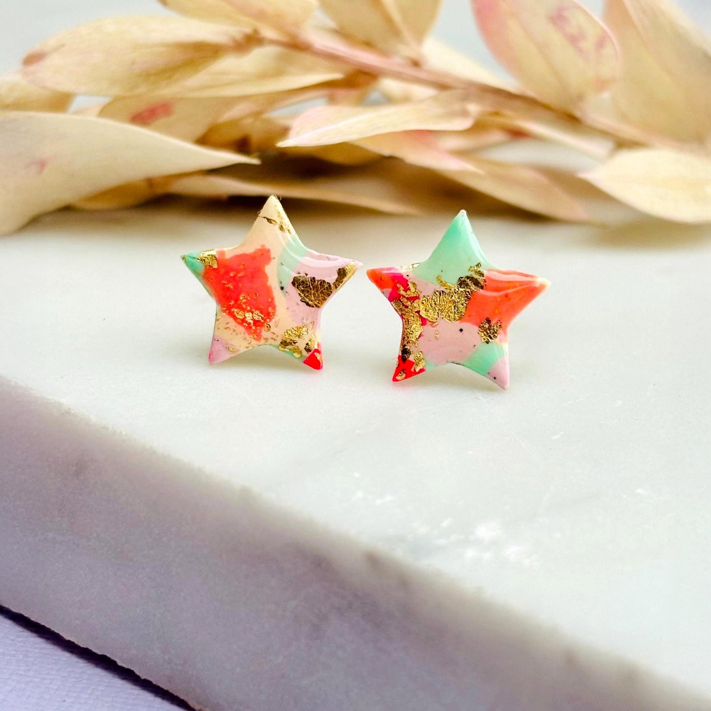 Colourful surf-inspired star stud earrings made from pink, mint, peach polymer clay with gold foil, featuring surgical steel posts and push backs.