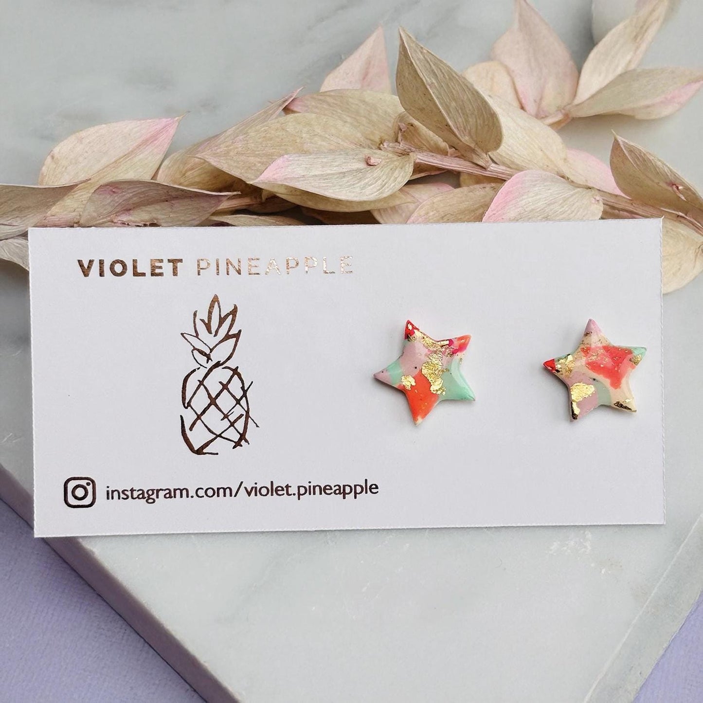 Colourful surf-inspired star stud earrings made from pink, mint, peach polymer clay with gold foil, featuring surgical steel posts and push backs.