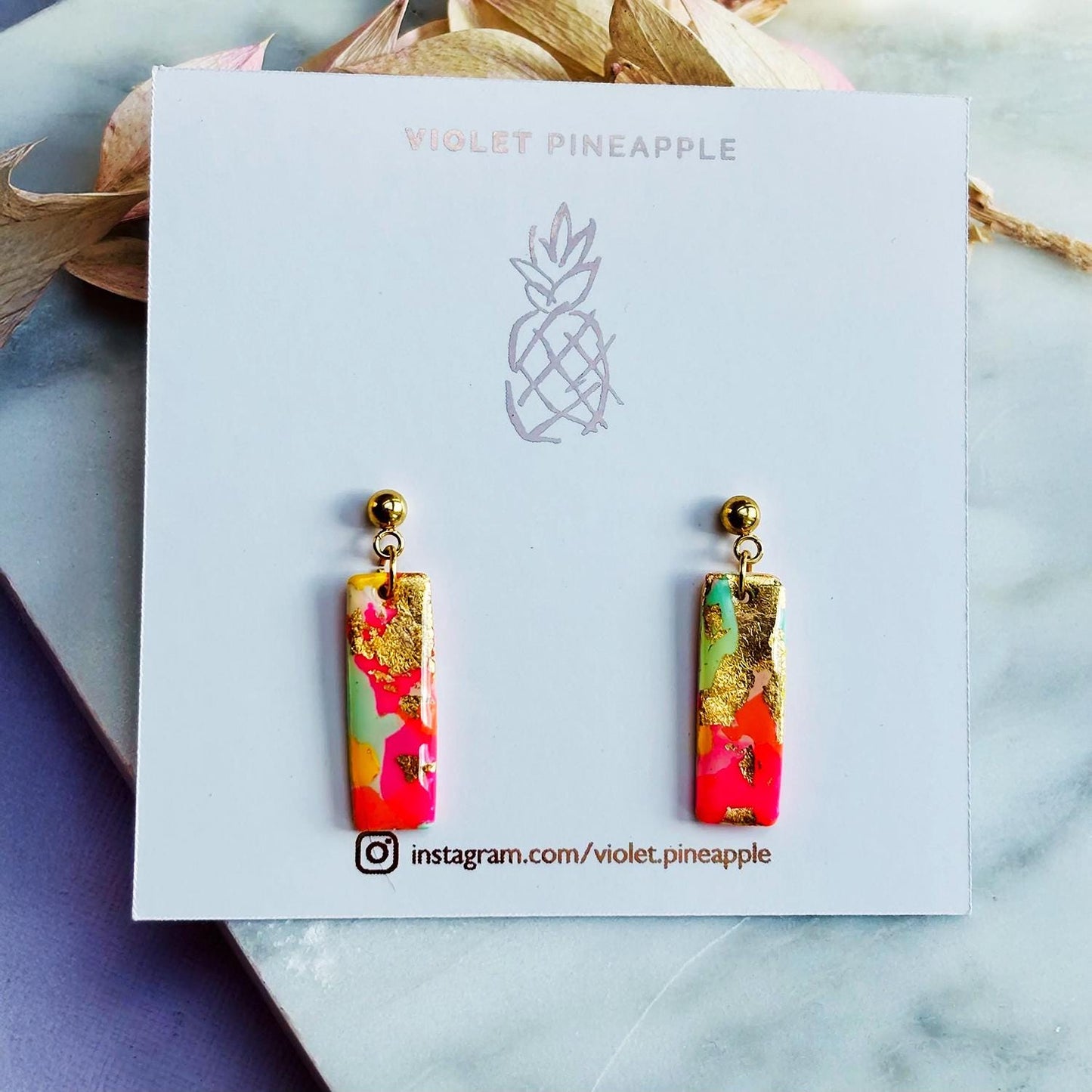 Colourful surf-inspired drop stud earrings with gold foil detail, handmade from polymer clay, featuring hypoallergenic surgical stainless steel posts and backings.