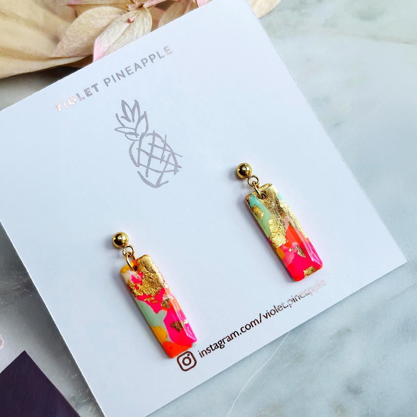 Colourful surf-inspired drop stud earrings with gold foil detail, handmade from polymer clay, featuring hypoallergenic surgical stainless steel posts and backings.