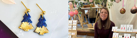 Handmade navy and gold foil Christmas tree drop earrings by Violet Pineapple (left) and founder Suzanne smiling at a busy Christmas craft fair stall (right).