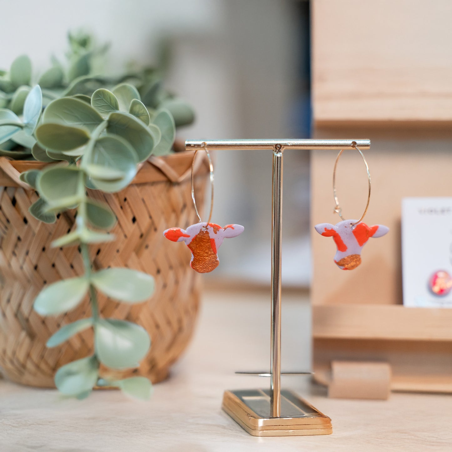 Cute cow earrings on display.