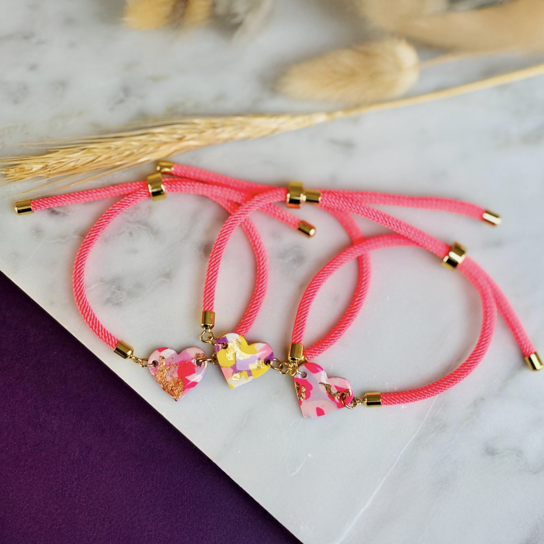 Handmade heart charm cord bracelet with an adjustable nylon cord. Available in pretty pink, gorgeous green, powder blue, and marvellous mauve.