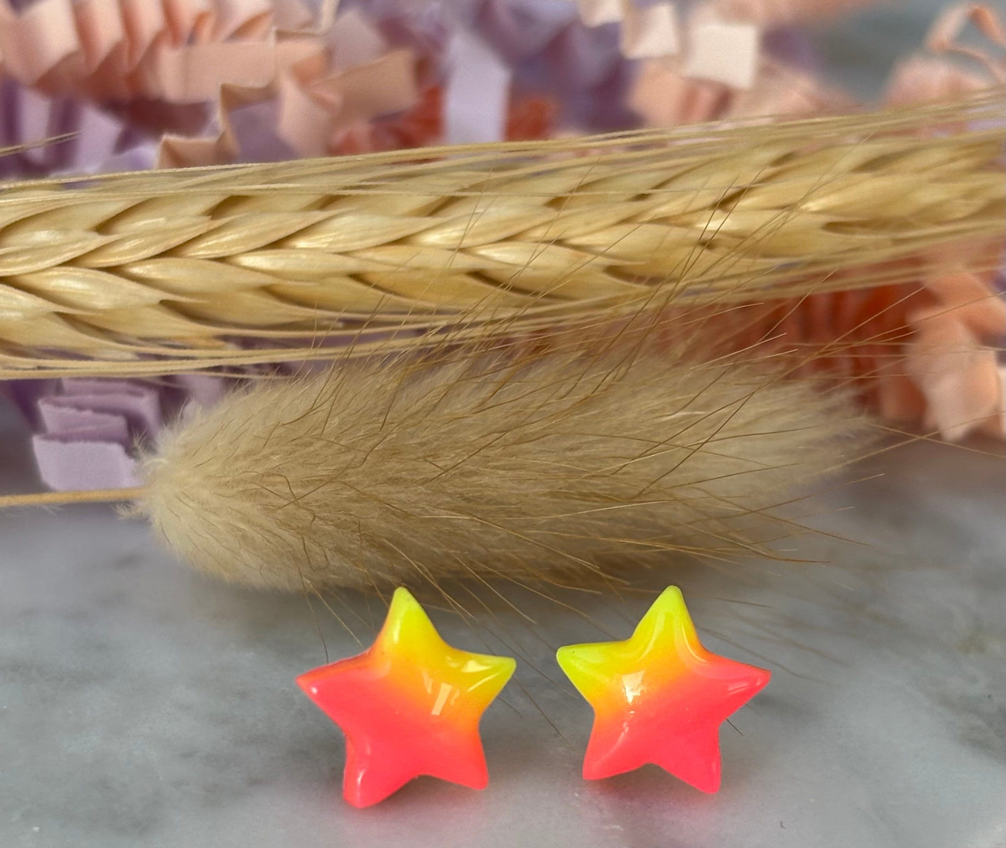 Quirky surf chic inspired mini star stud earrings with a bright pink and yellow ombré blend, handmade with polymer clay.
