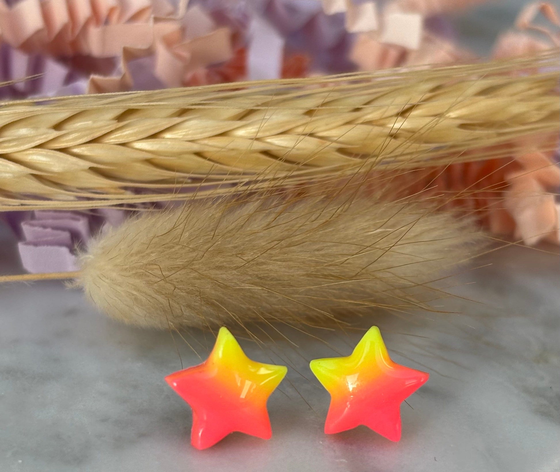 Quirky surf chic inspired mini star stud earrings with a bright pink and yellow ombré blend, handmade with polymer clay.