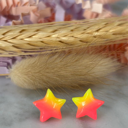 Quirky surf chic inspired mini star stud earrings with a bright pink and yellow ombré blend, handmade with polymer clay.