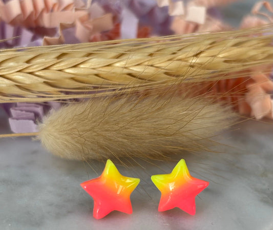 Quirky surf chic inspired mini star stud earrings with a bright pink and yellow ombré blend, handmade with polymer clay.