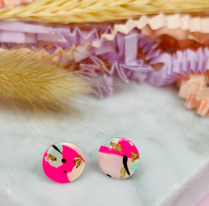 Vibrant 90s-inspired stud earrings with a neon pink, mint, and black ink design, handmade with polymer clay.