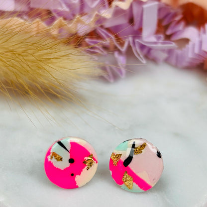 Vibrant 90s-inspired stud earrings with a neon pink, mint, and black ink design, handmade with polymer clay.