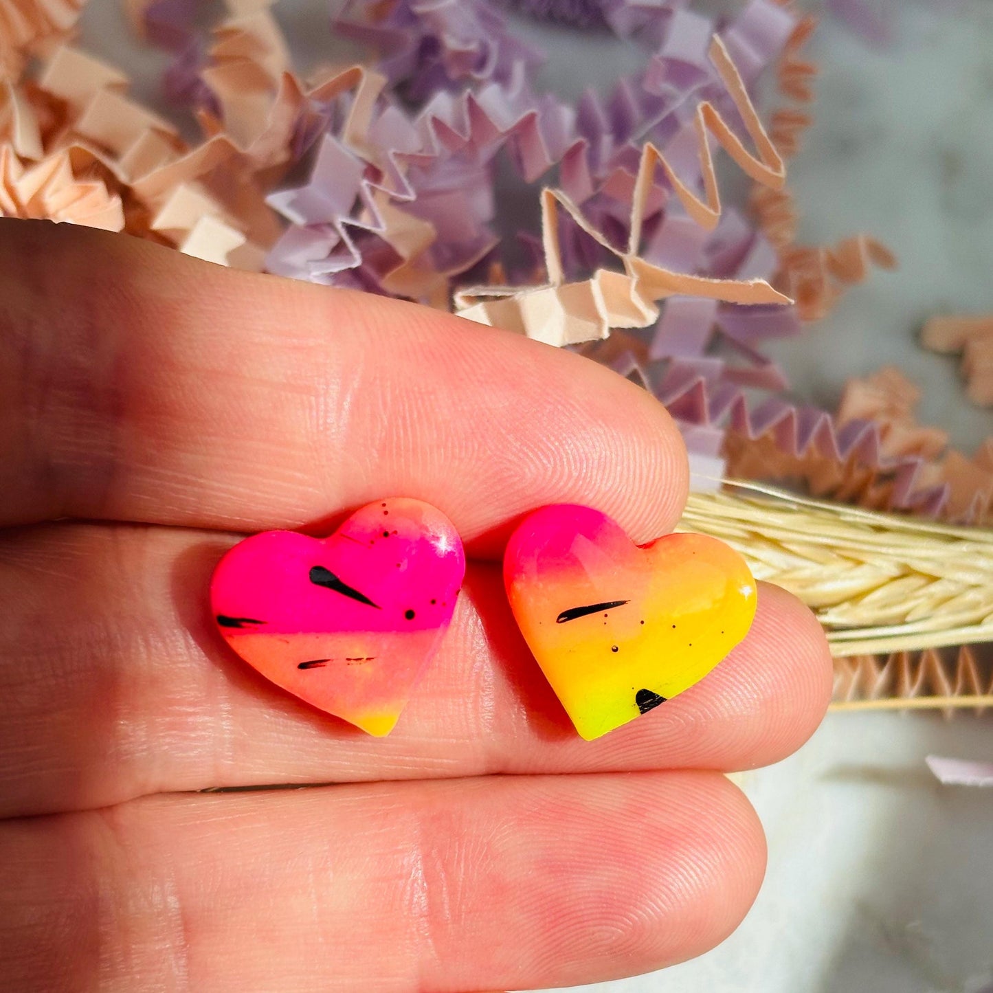 Vibrant 80s disco-inspired heart-shaped stud earrings, handmade with polymer clay. Features a bold color palette with yellow, pink, and black ink splatter.