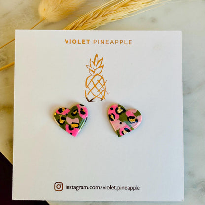 Elegant heart-shaped stud earrings with a hand painted leopard print, handmade with polymer clay