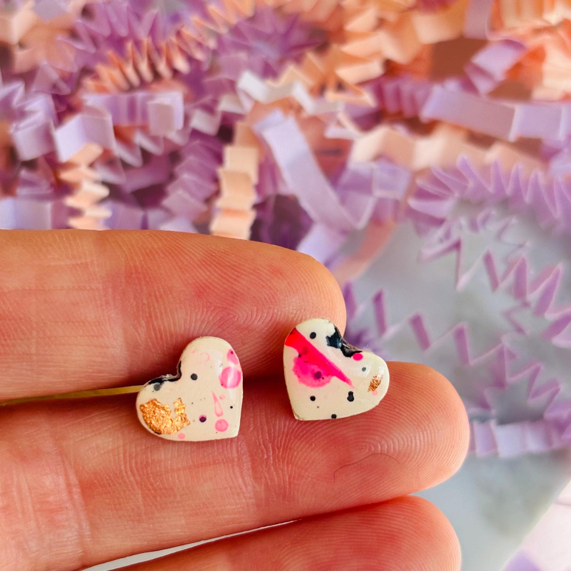 Quirky 90s-inspired neon pink heart-shaped stud earrings, handmade with polymer clay.