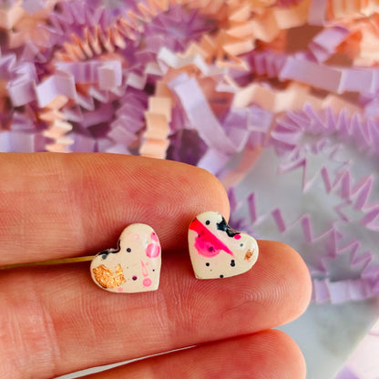 Quirky 90s-inspired neon pink heart-shaped stud earrings, handmade with polymer clay.