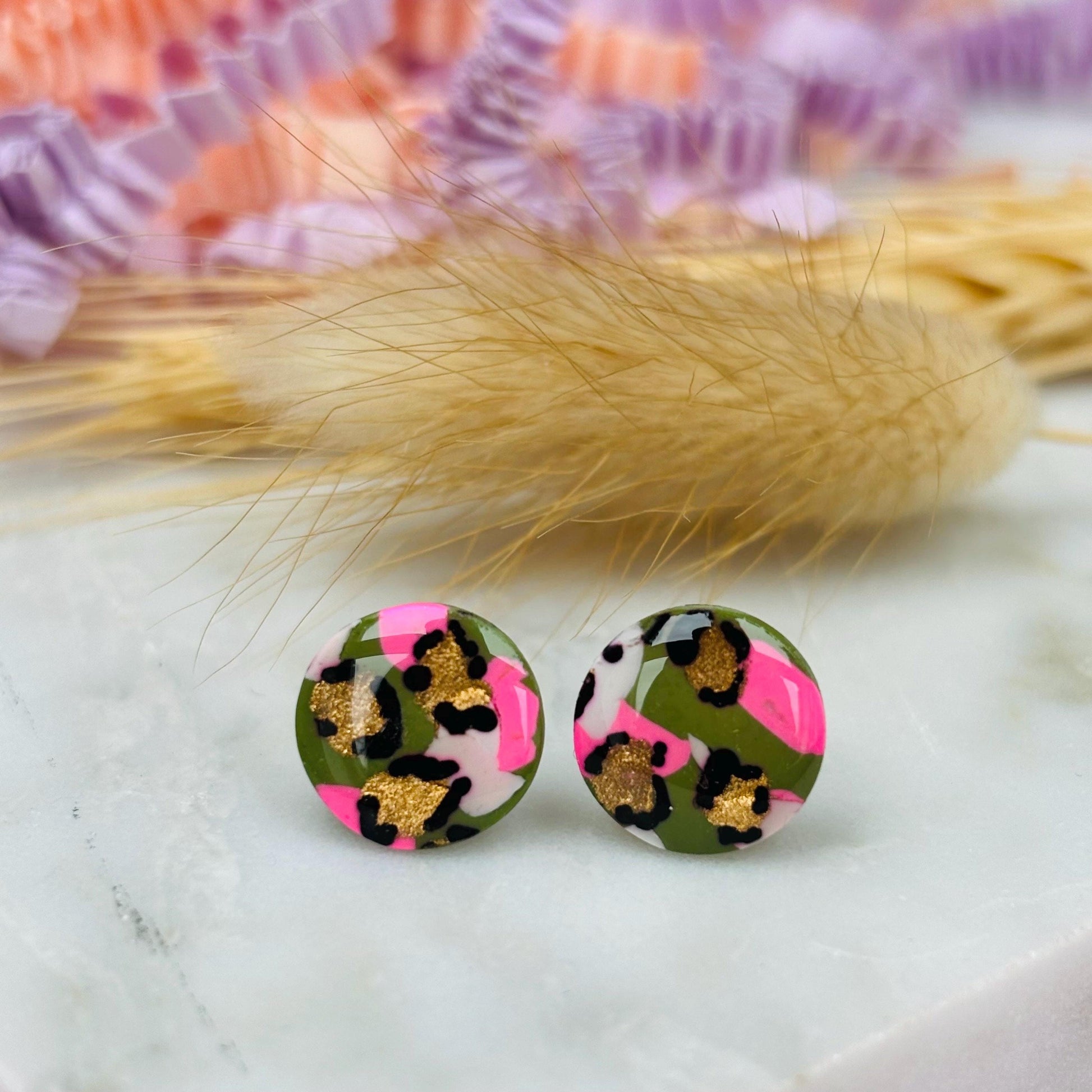 Vibrant leopard print stud earrings, handmade with polymer clay.