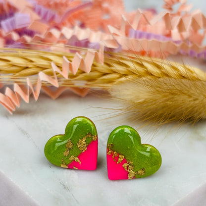 Tropical watermelon-inspired heart-shaped stud earrings, handmade with polymer clay. Features emerald green and neon pink with gold foil accents.