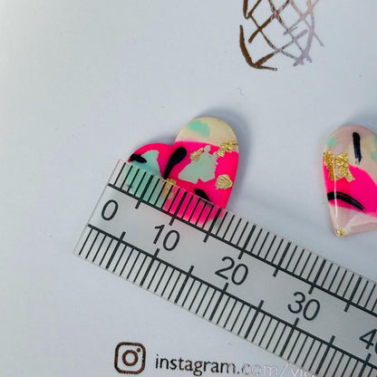 Vibrant 90s punk-inspired heart-shaped stud earrings, handmade with polymer clay. Features neon pink, mint, black ink, and gold leaf accents.