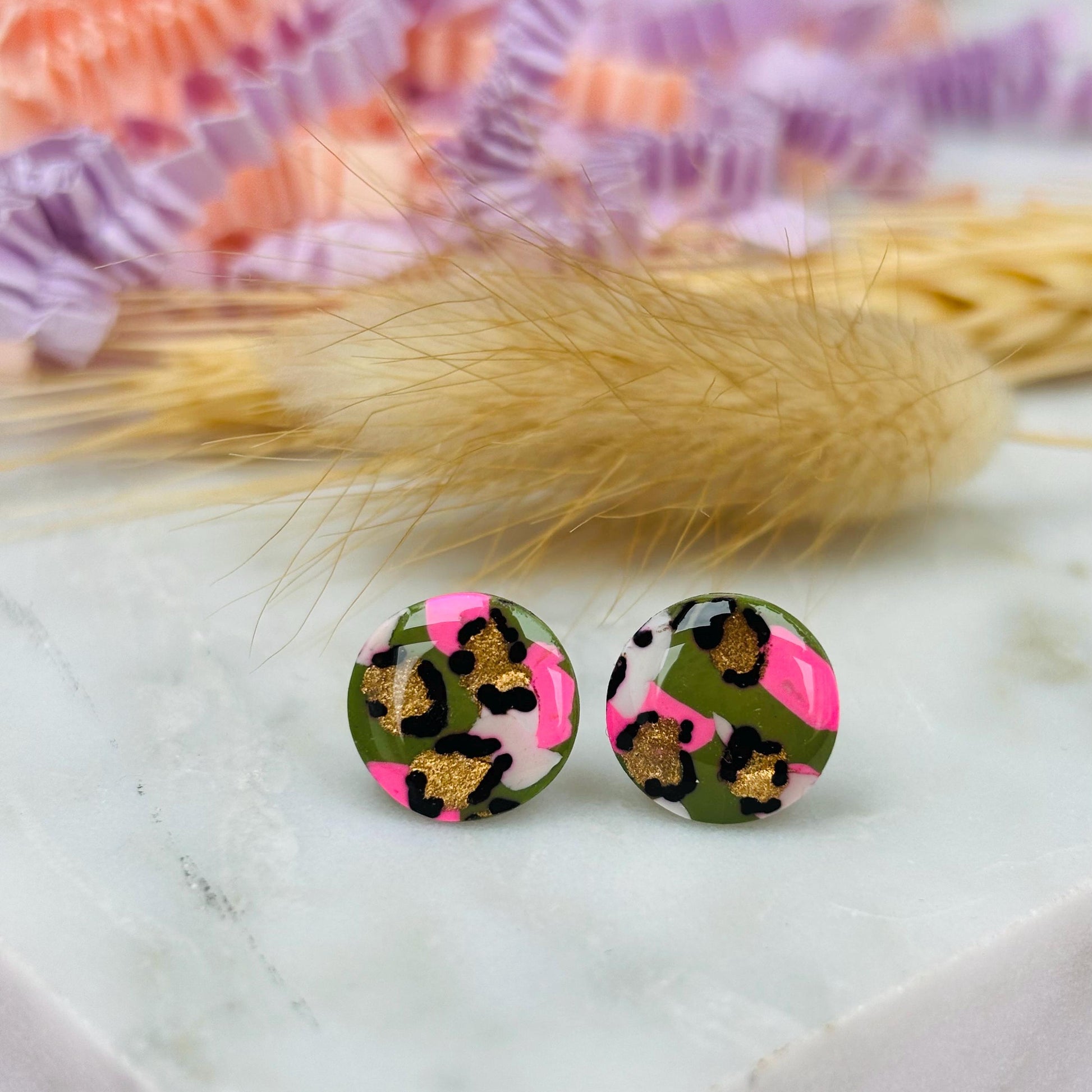 Vibrant leopard print stud earrings, handmade with polymer clay.