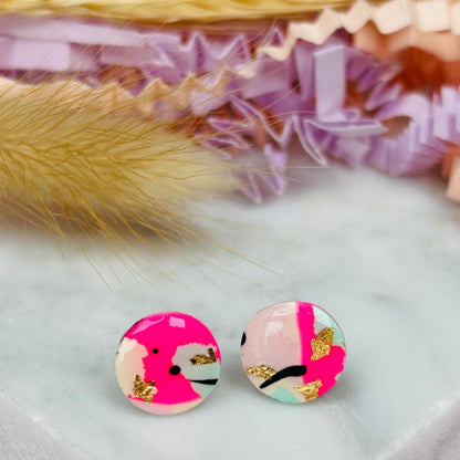 Vibrant 90s-inspired stud earrings with a neon pink, mint, and black ink design, handmade with polymer clay.
