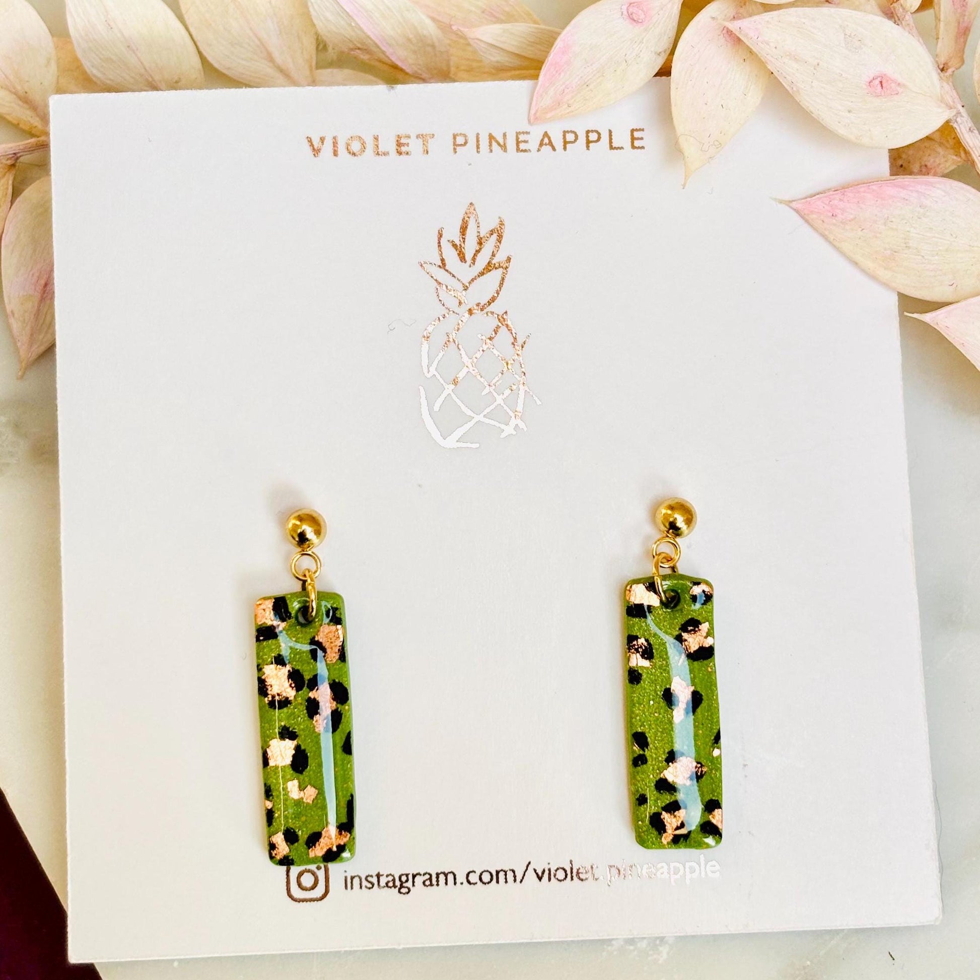 Elegant leopard print drop earrings with gold foil accents, hand-painted and handmade with polymer clay.