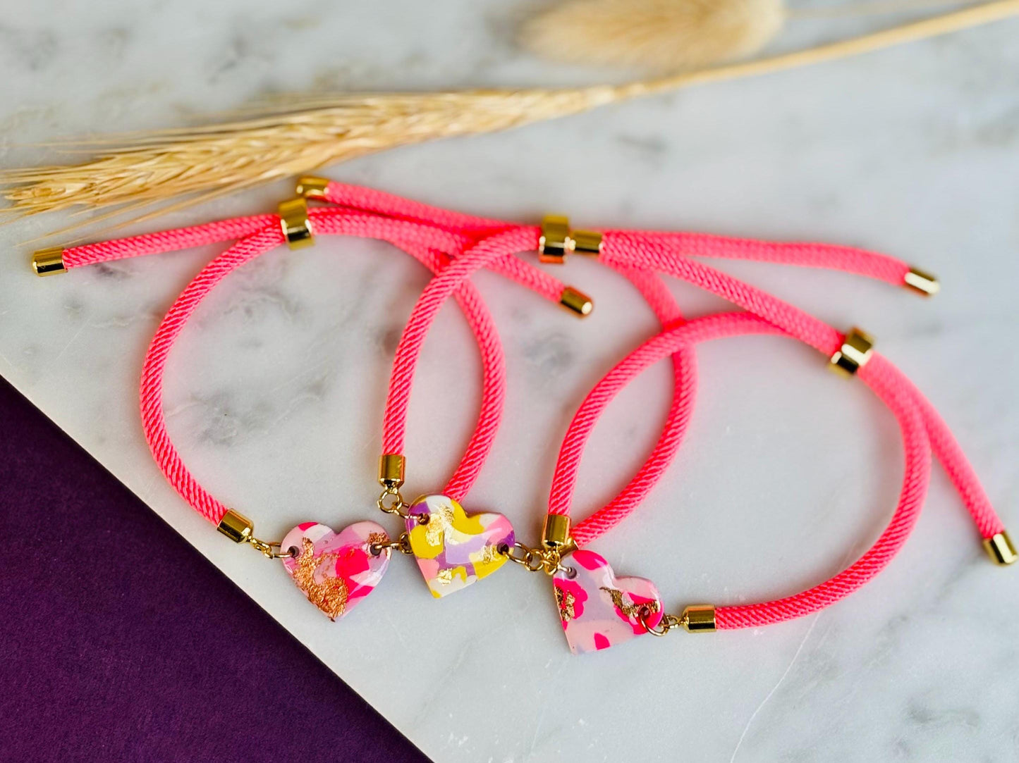 Handmade heart charm cord bracelet with an adjustable nylon cord. Available in pretty pink, gorgeous green, powder blue, and marvellous mauve.