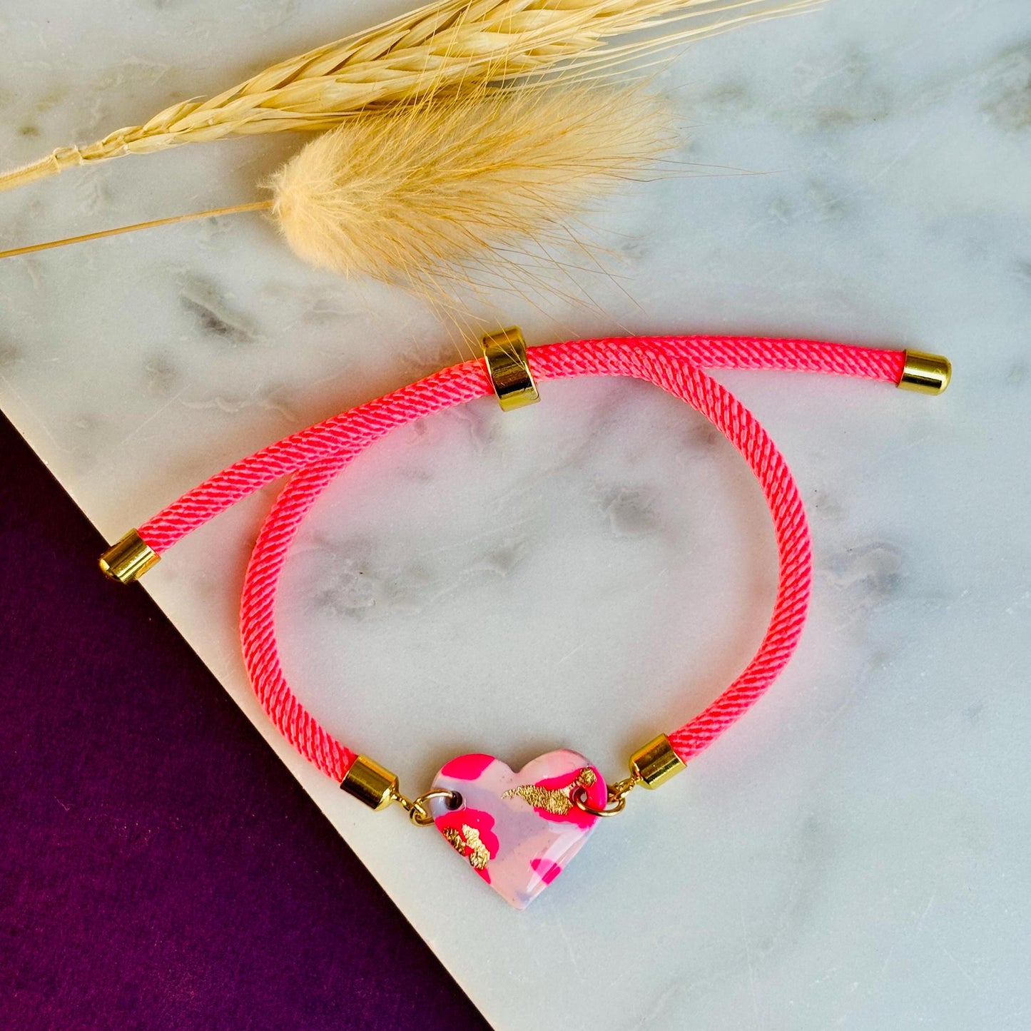 Handmade heart charm cord bracelet with an adjustable nylon cord. Available in pretty pink, gorgeous green, powder blue, and marvellous mauve.