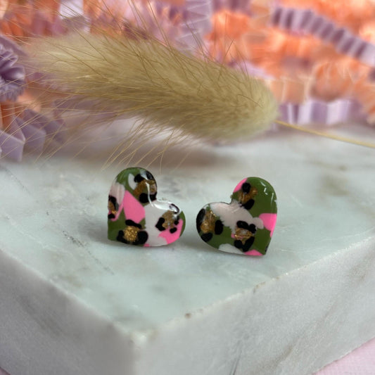 Small leopard print heart stud earrings in green and pink.