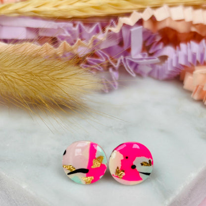 Vibrant 90s-inspired stud earrings with a neon pink, mint, and black ink design, handmade with polymer clay.