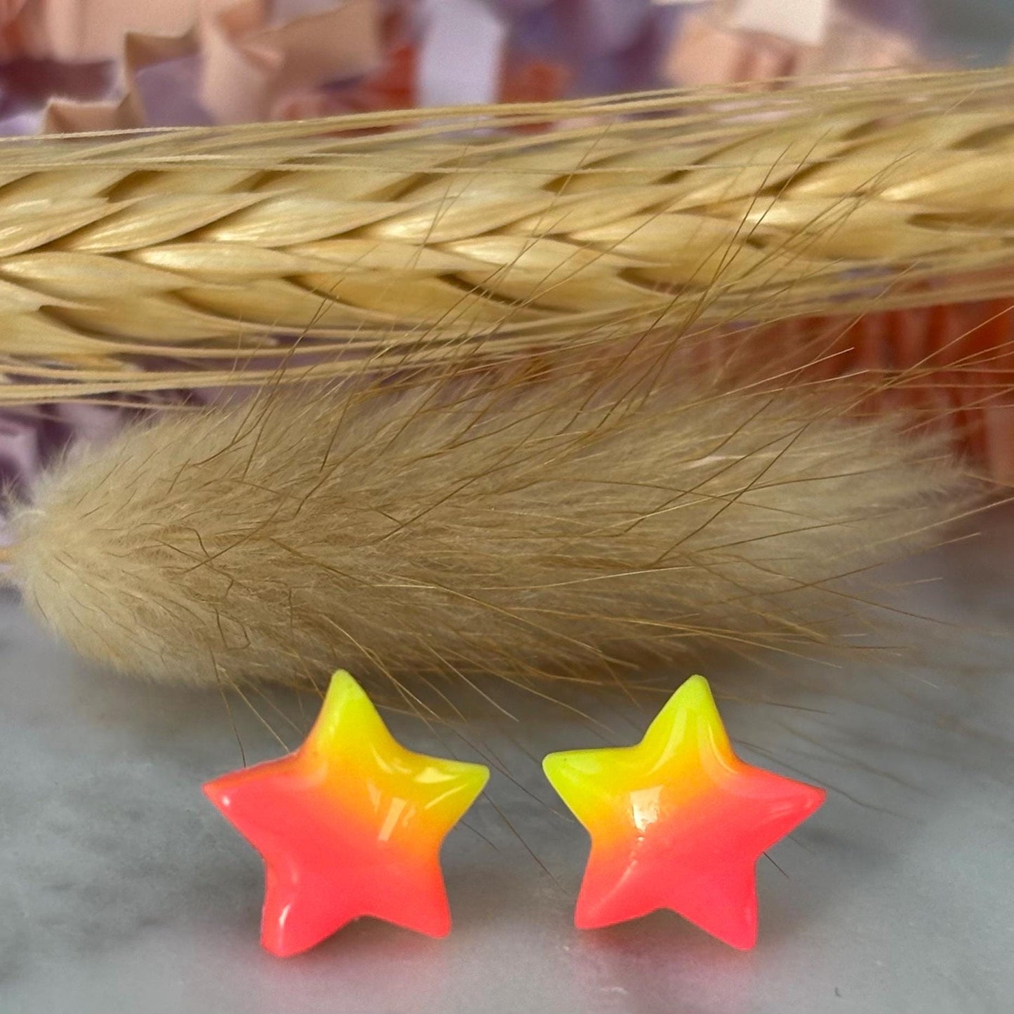 Quirky surf chic inspired mini star stud earrings with a bright pink and yellow ombré blend, handmade with polymer clay.