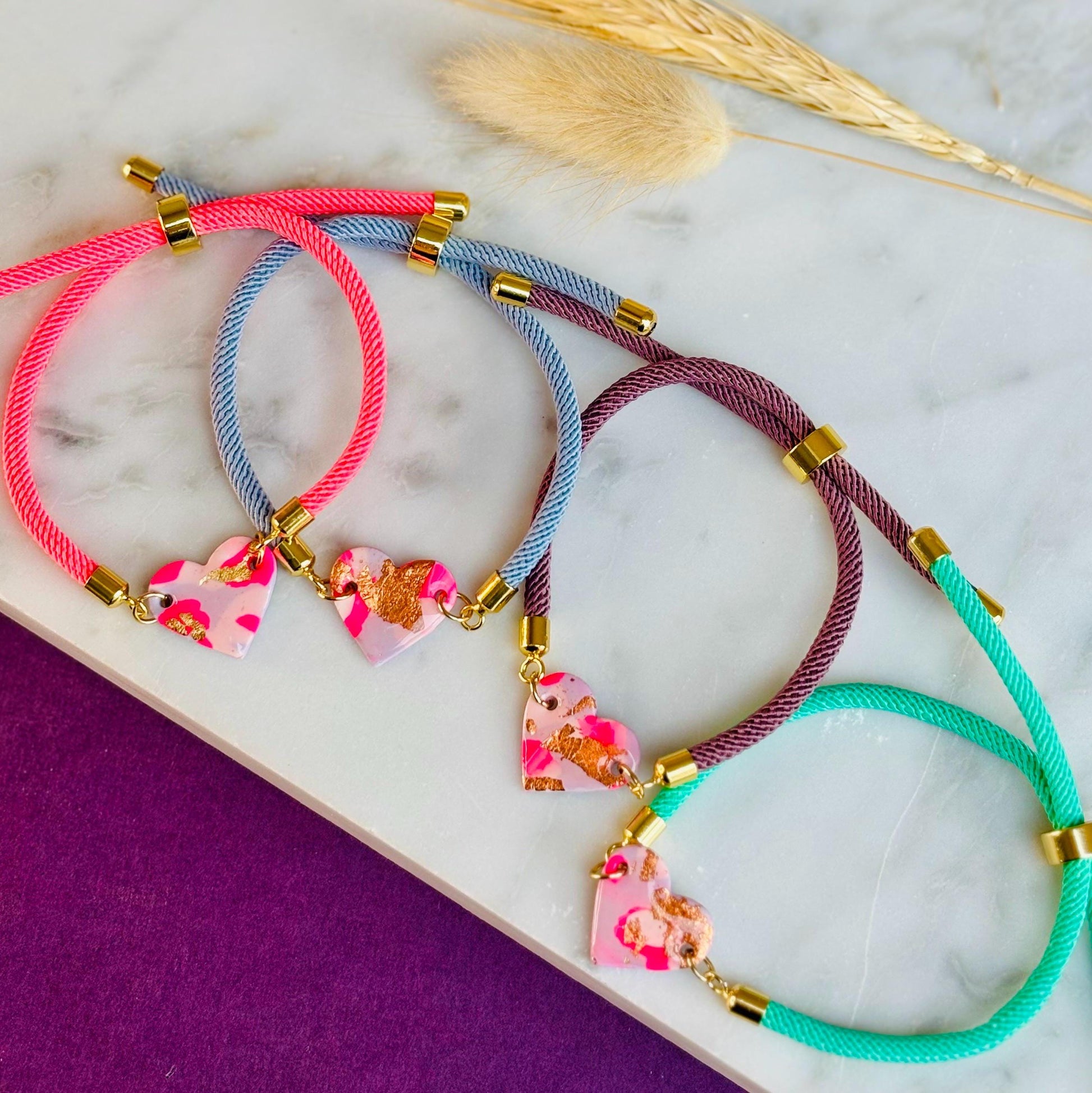 Handmade heart charm cord bracelet with an adjustable nylon cord. Available in pretty pink, gorgeous green, powder blue, and marvellous mauve.