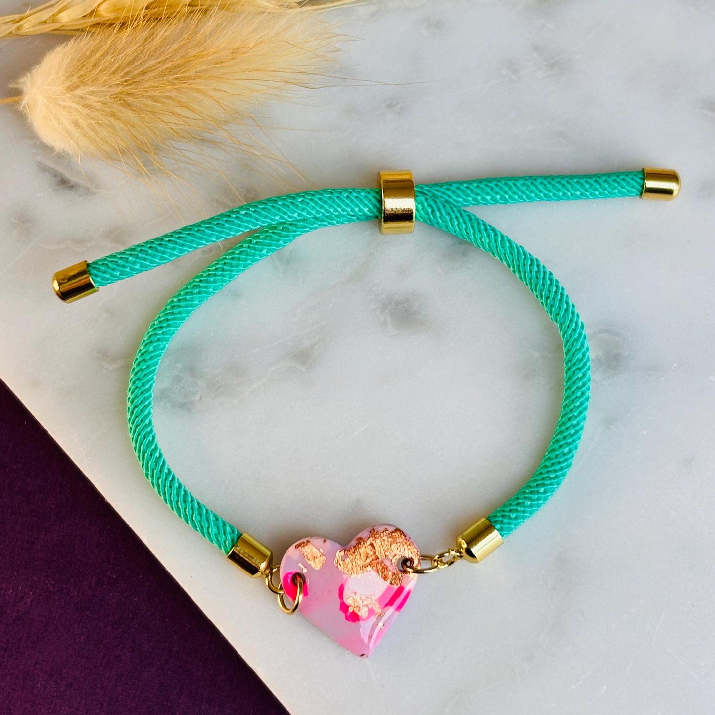 Handmade heart charm cord bracelet with an adjustable nylon cord. Available in pretty pink, gorgeous green, powder blue, and marvellous mauve.
