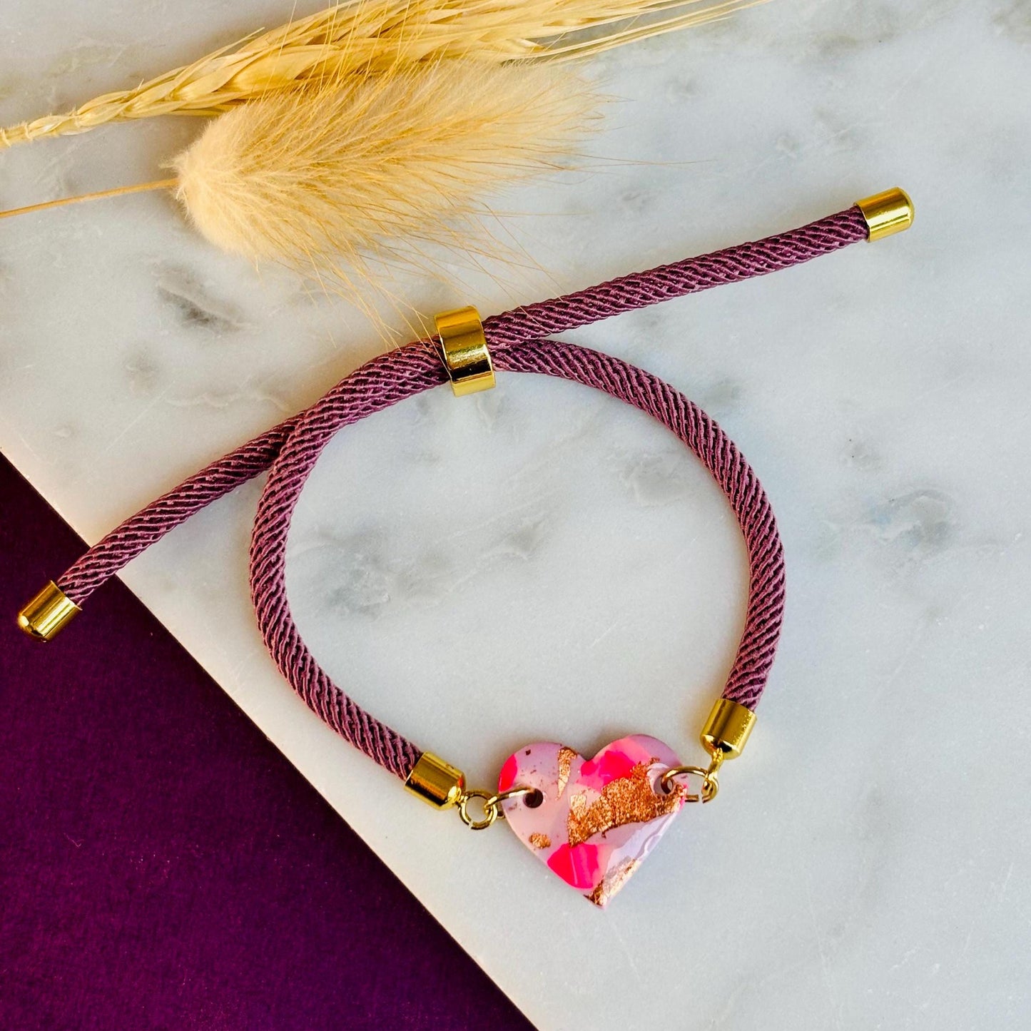 Handmade heart charm cord bracelet with an adjustable nylon cord. Available in pretty pink, gorgeous green, powder blue, and marvellous mauve.