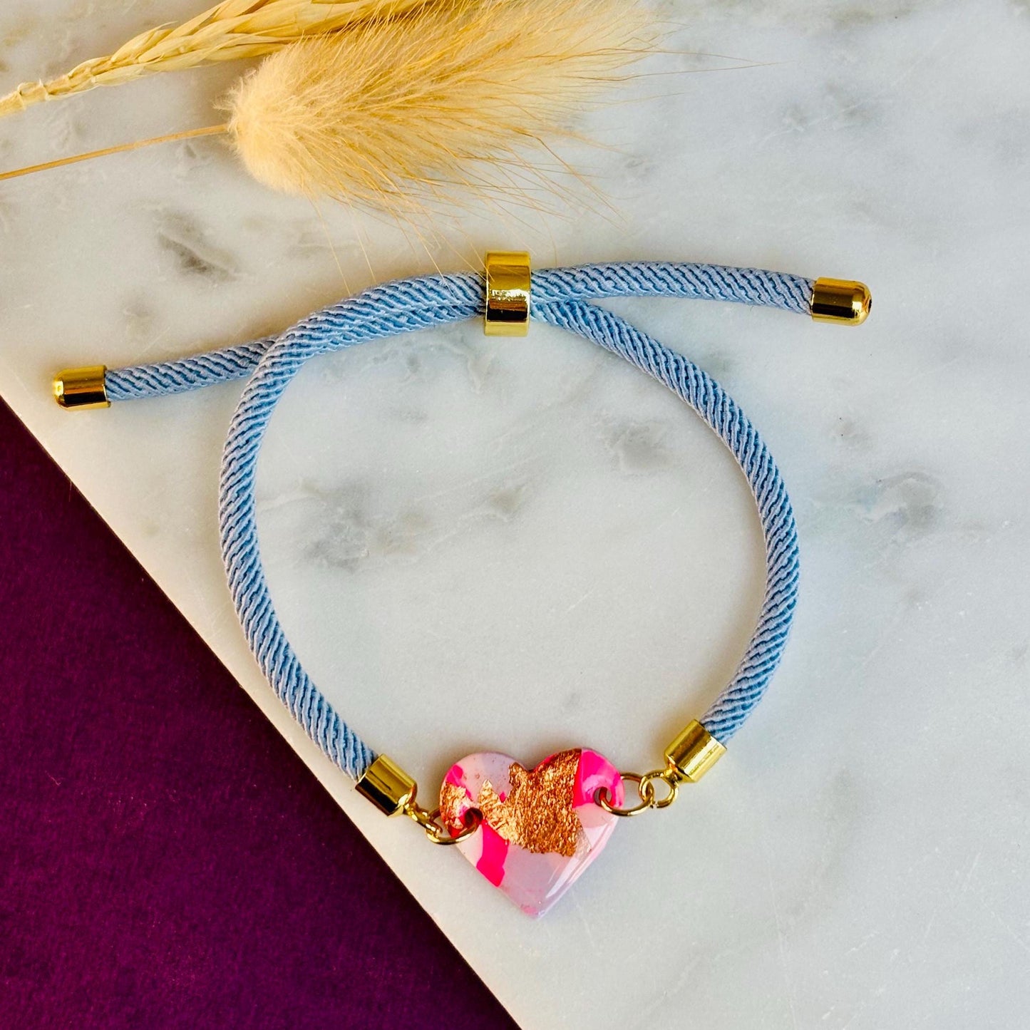 Handmade heart charm cord bracelet with an adjustable nylon cord. Available in pretty pink, gorgeous green, powder blue, and marvellous mauve.
