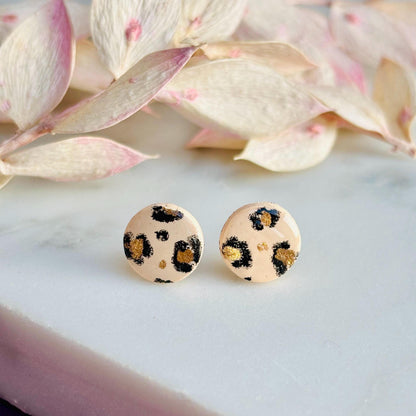 Elegant leopard print drop stud earrings with neutral tones and gold accents, hand-painted and handmade with polymer clay.
