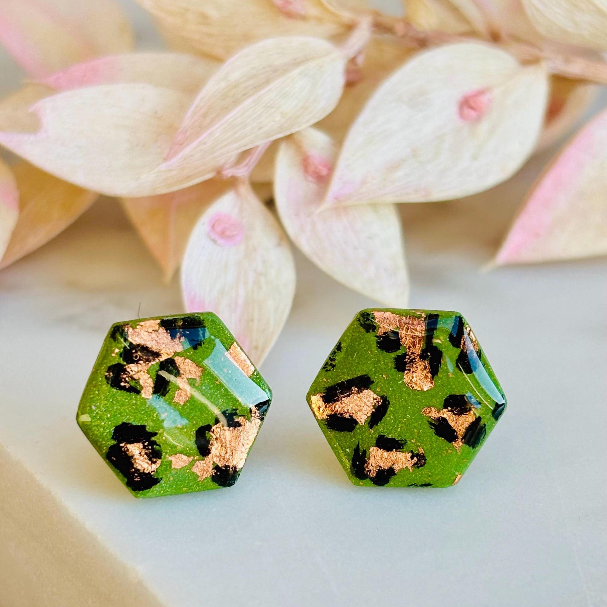 Leopard print hexagon stud earrings with hand-painted spots, handmade with polymer clay. 15mm x 15mm.