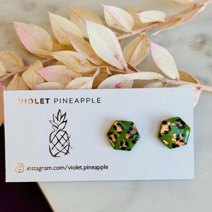 Leopard print hexagon stud earrings with hand-painted spots, handmade with polymer clay. 15mm x 15mm.