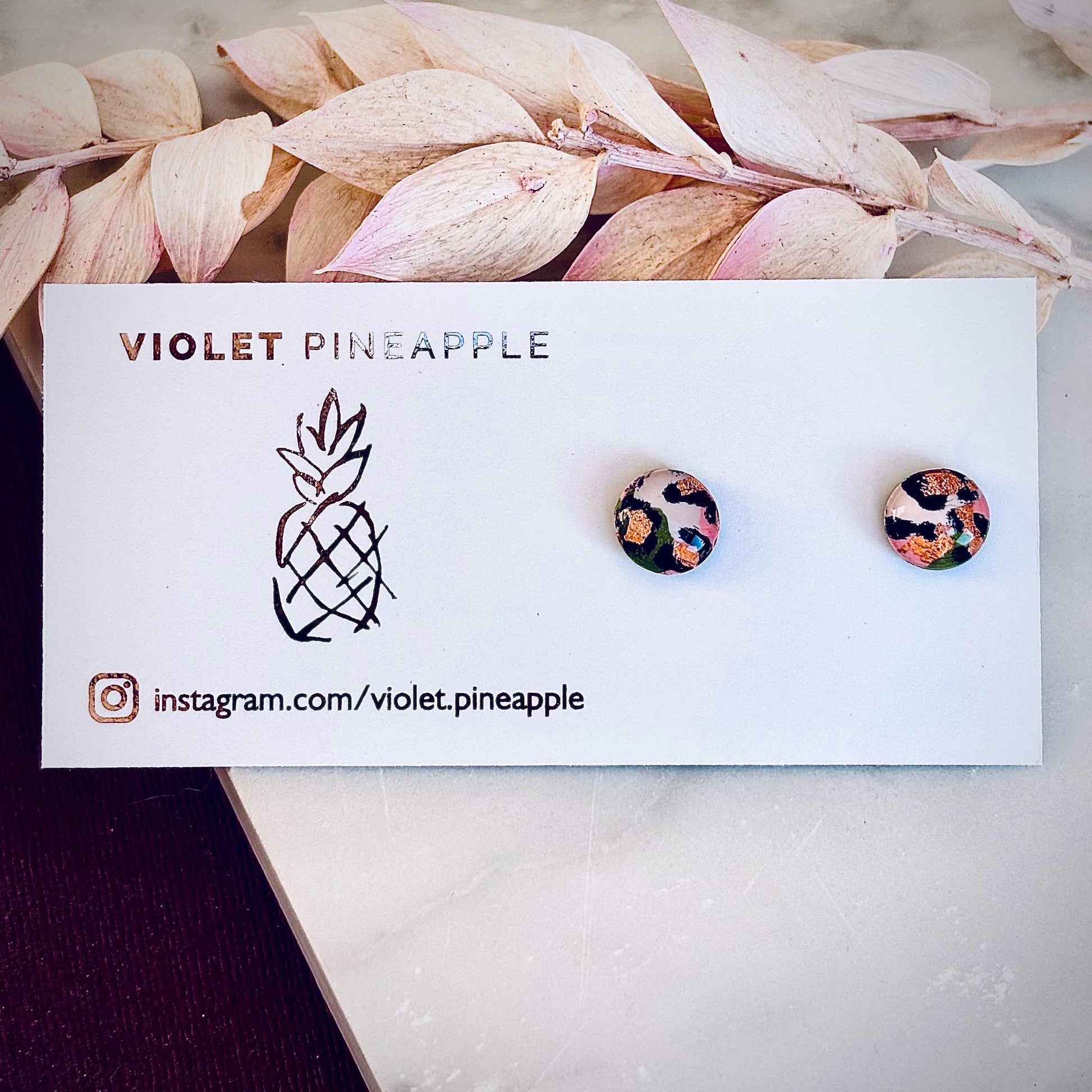 Petite leopard print stud earrings, 8mm x 8mm, with hand-painted spots in olive green and peach tones, handmade from polymer clay.