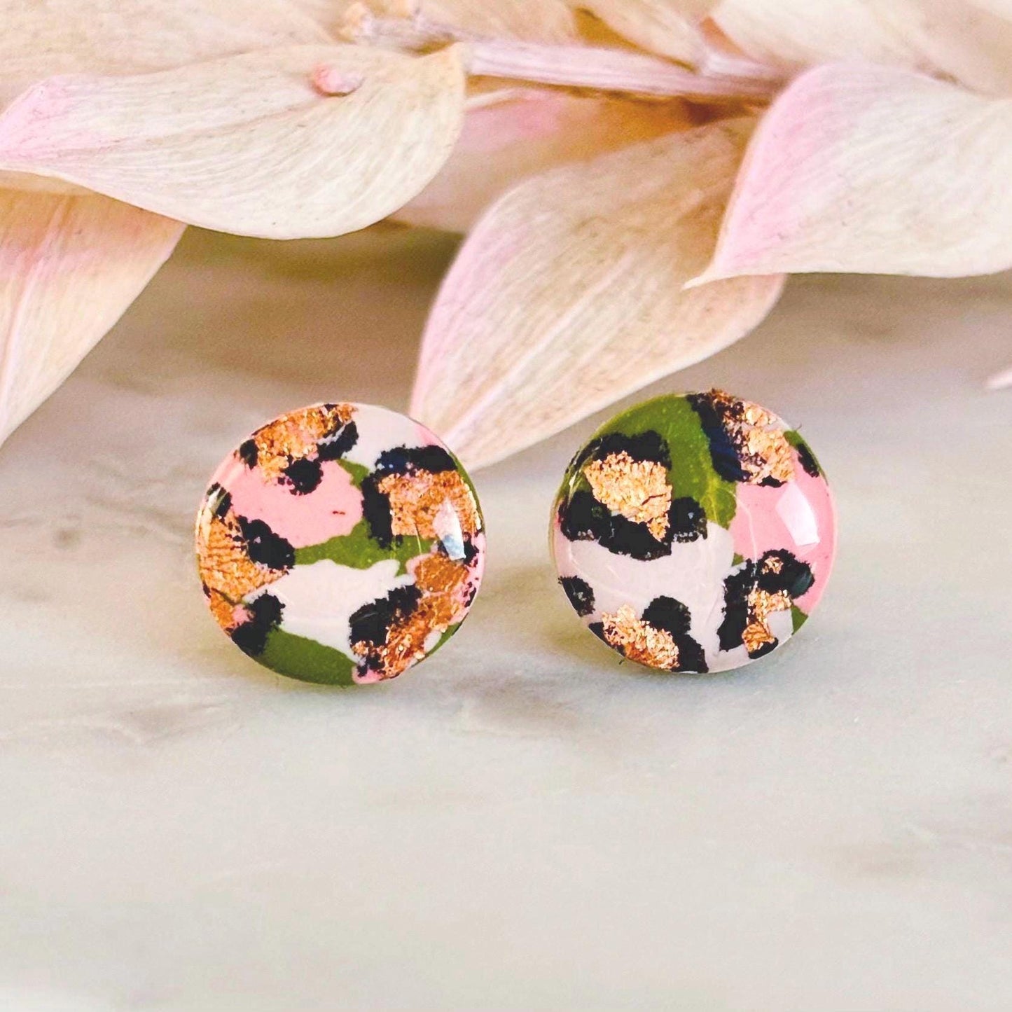 Vivid leopard print stud earrings, 10mm x 10mm, with hand-painted spots in peach, olive green, and rose gold, handmade from polymer clay.