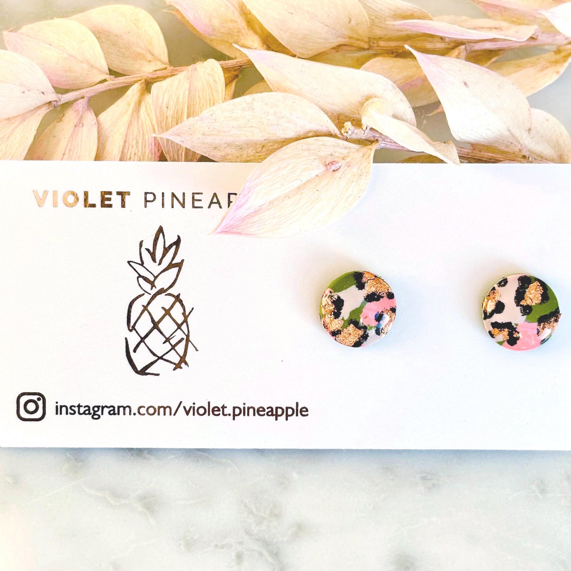 Vivid leopard print stud earrings, 10mm x 10mm, with hand-painted spots in peach, olive green, and rose gold, handmade from polymer clay.