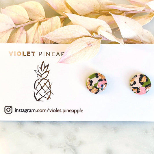 Vivid leopard print stud earrings, 10mm x 10mm, with hand-painted spots in peach, olive green, and rose gold, handmade from polymer clay.
