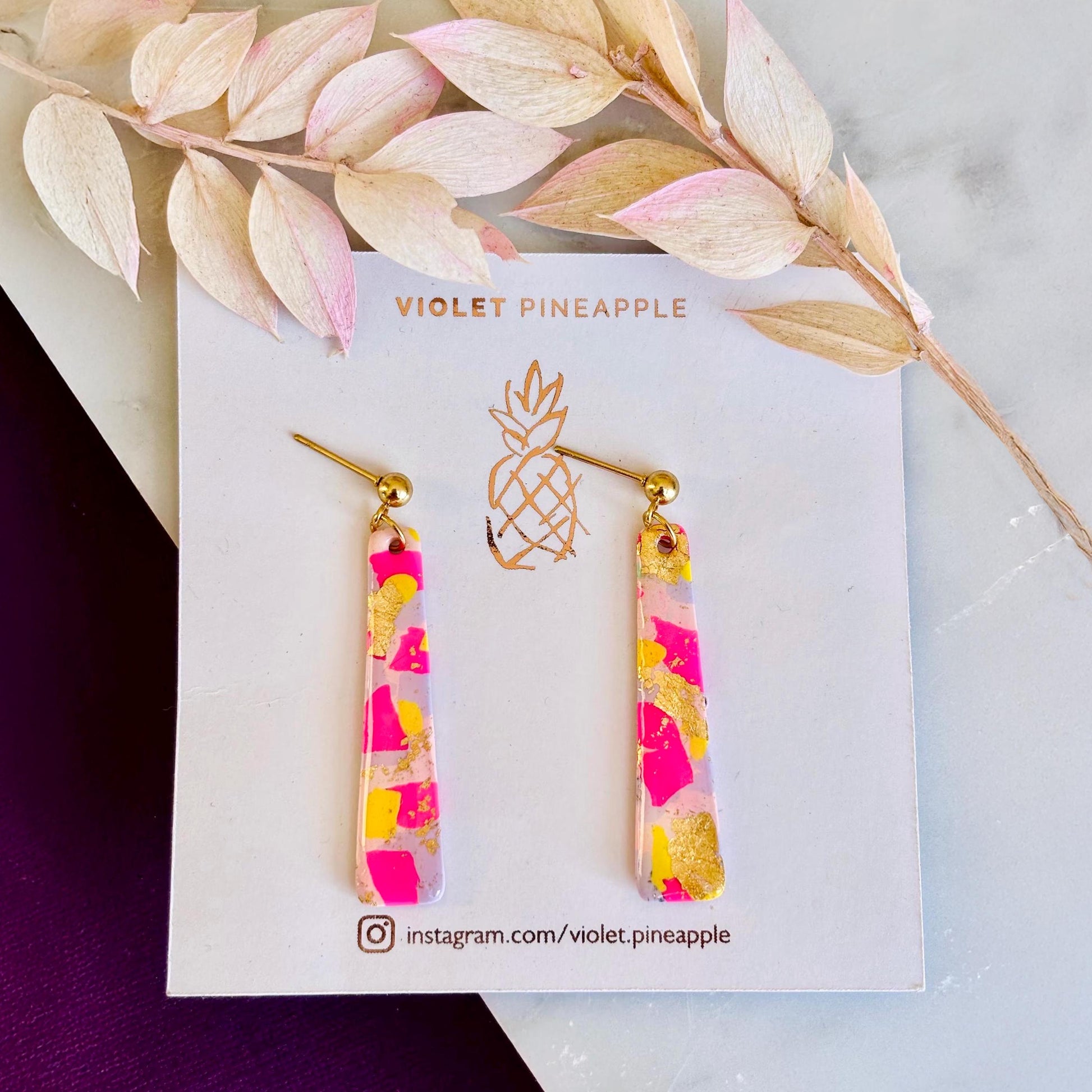 Delicate pastel drop stud earrings with soft pink, blue, and yellow hues and shimmering gold foil detailing, handcrafted from polymer clay.