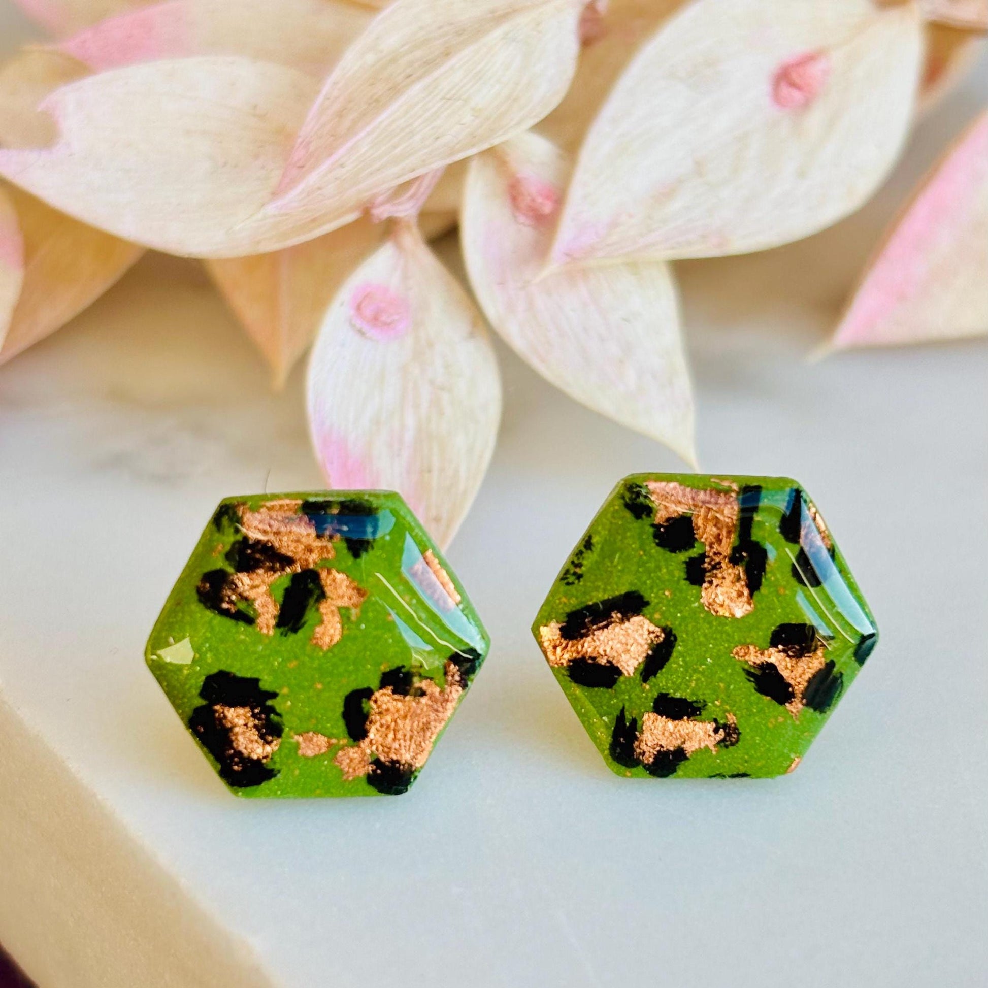 Leopard print hexagon stud earrings with hand-painted spots, handmade with polymer clay. 15mm x 15mm.