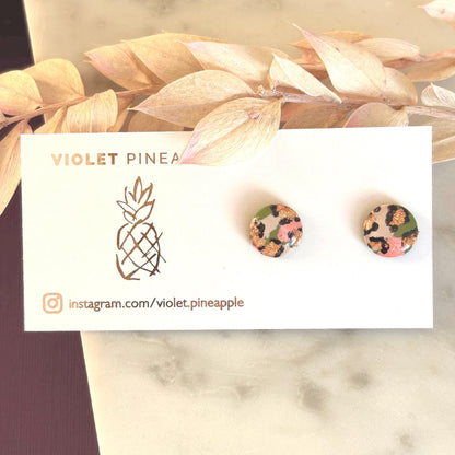 Vivid leopard print stud earrings, 10mm x 10mm, with hand-painted spots in peach, olive green, and rose gold, handmade from polymer clay.