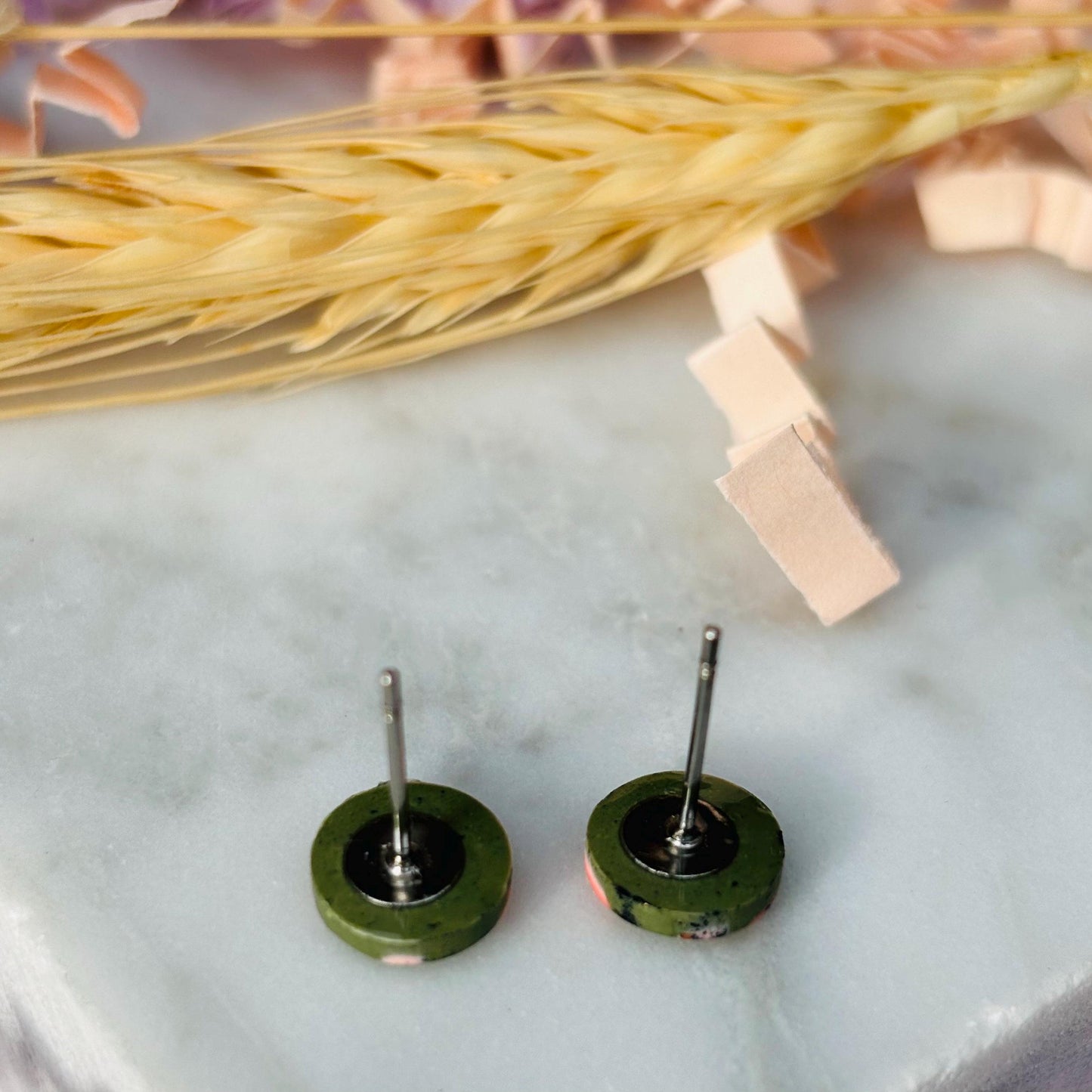 Petite leopard print stud earrings, 8mm x 8mm, with hand-painted spots in olive green and peach tones, handmade from polymer clay.
