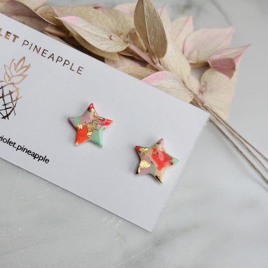 Colourful surf-inspired star stud earrings made from pink, mint, peach polymer clay with gold foil, featuring surgical steel posts and push backs.