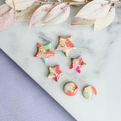 Colourful surf-inspired star stud earrings made from pink, mint, peach polymer clay with gold foil, featuring surgical steel posts and push backs.